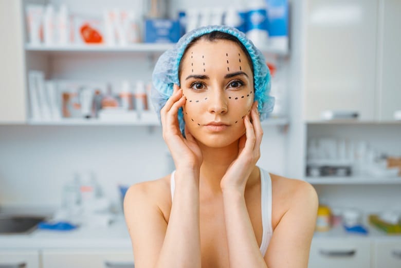 female patient with markers on her face cosmetician s office rejuvenation procedure in beautician salon cosmetic surgery against wrinkles preparation to